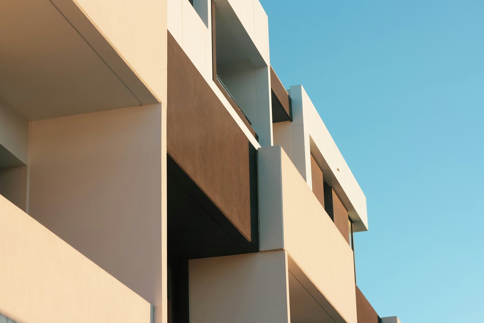 Modern residential building with deep balconies against a clear sky